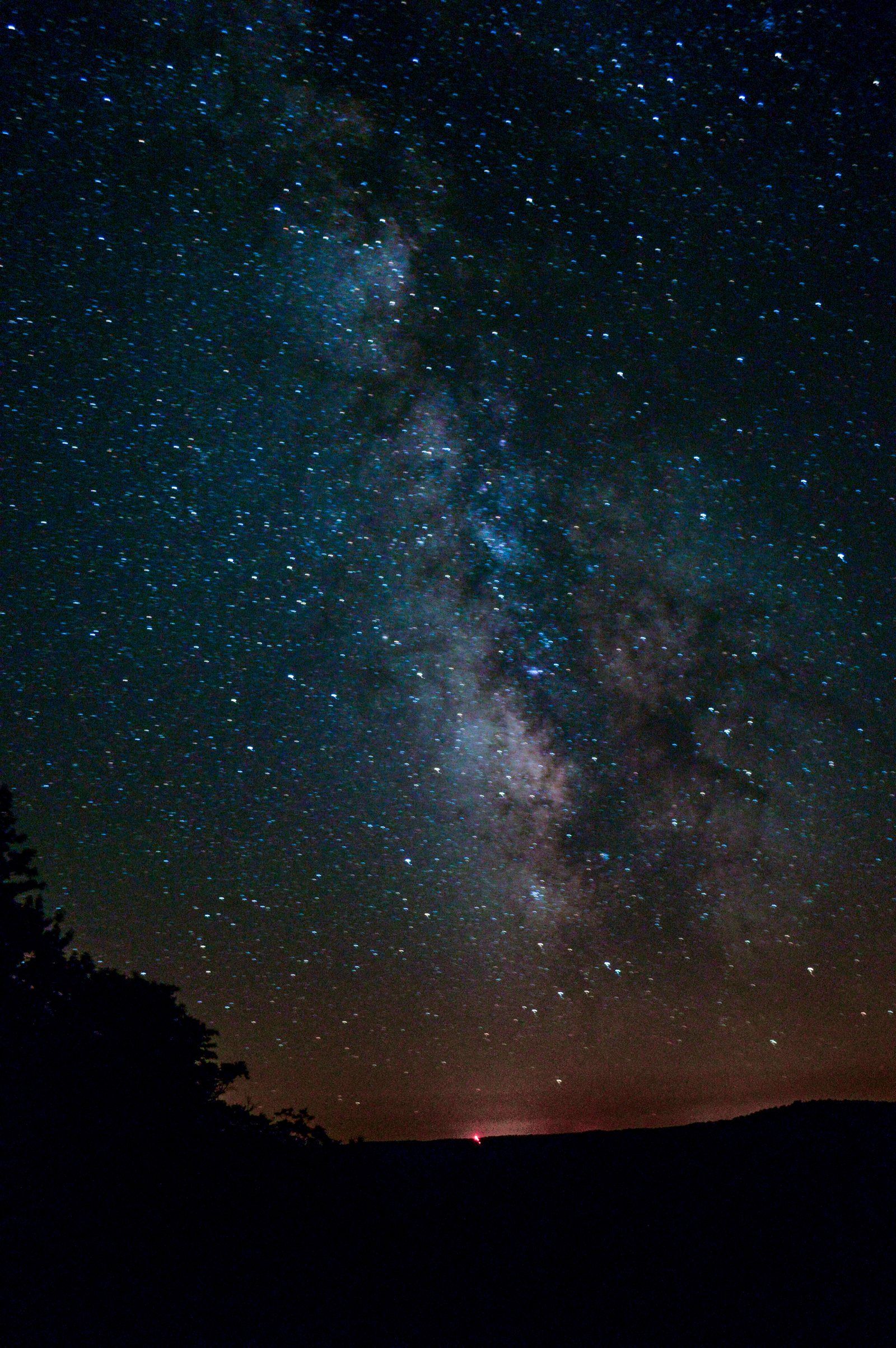 The Milky Way arching vertically over the horizon at Cherry Springs State Park